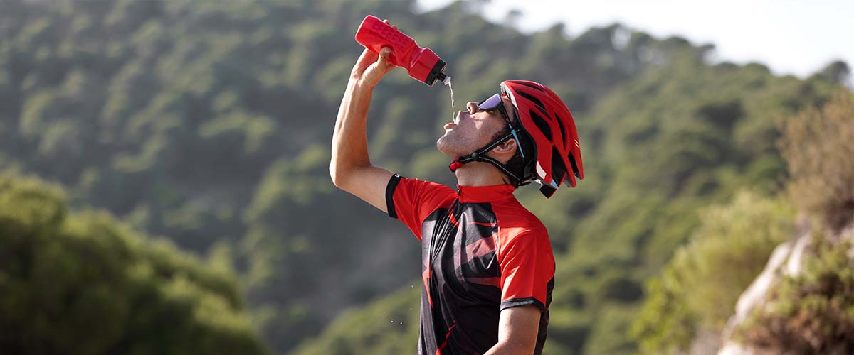 Cyclist drinking water on the route